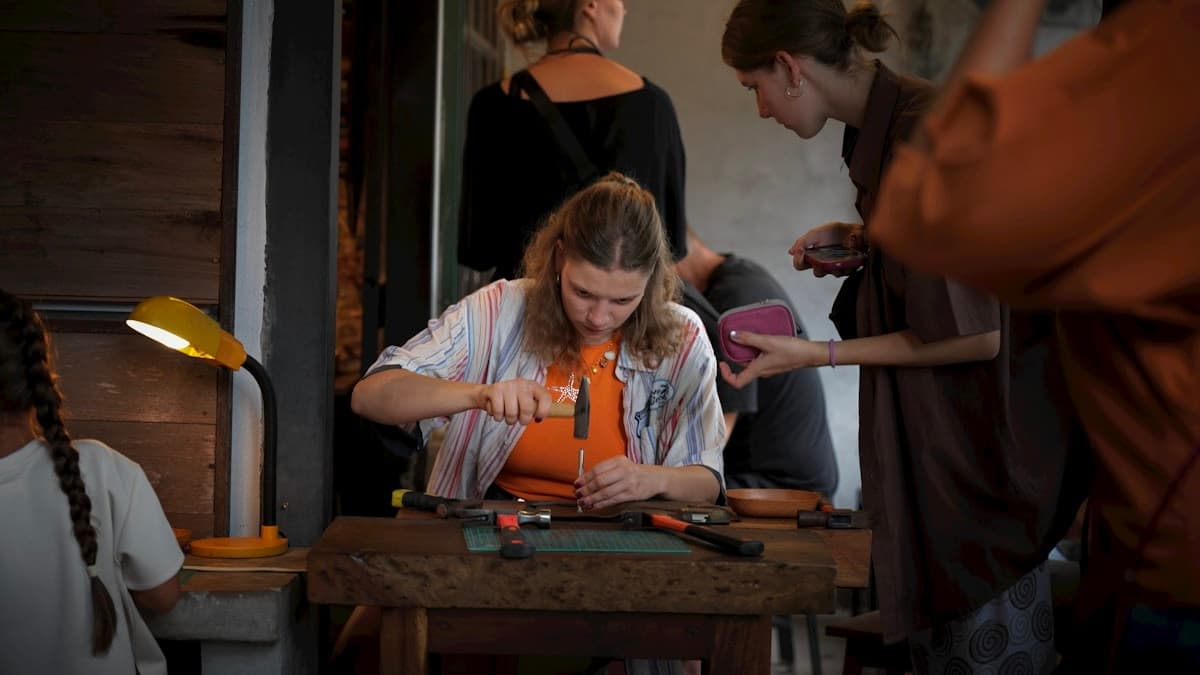 Hand-finishing a leather piece at a workbench